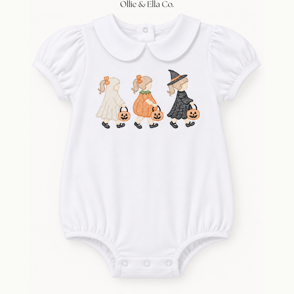 A white short-sleeve baby bodysuit with a Peter Pan collar, featuring a printed graphic of three children in Halloween costumes (ghost, pumpkin, and witch) walking with jack-o'-lanterns. The brand name 'Ollie & Ella Co.