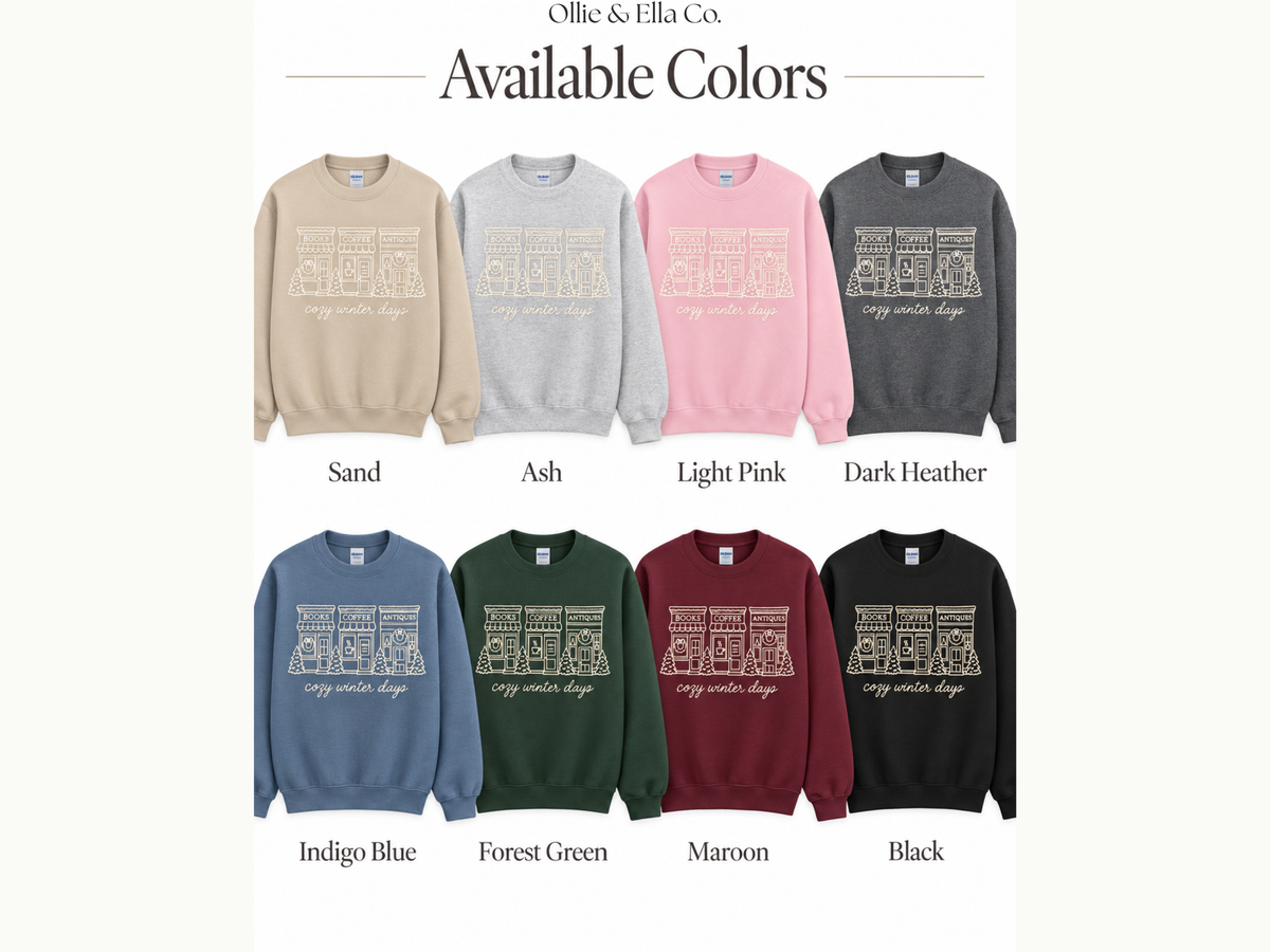 A color-options graphic for Ollie & Ella Co. showing eight crewneck sweatshirts in different colors, labeled Sand, Ash, Light Pink, Dark Heather, Indigo Blue, Forest Green, Maroon, and Black, under the heading 'Available Colors'.