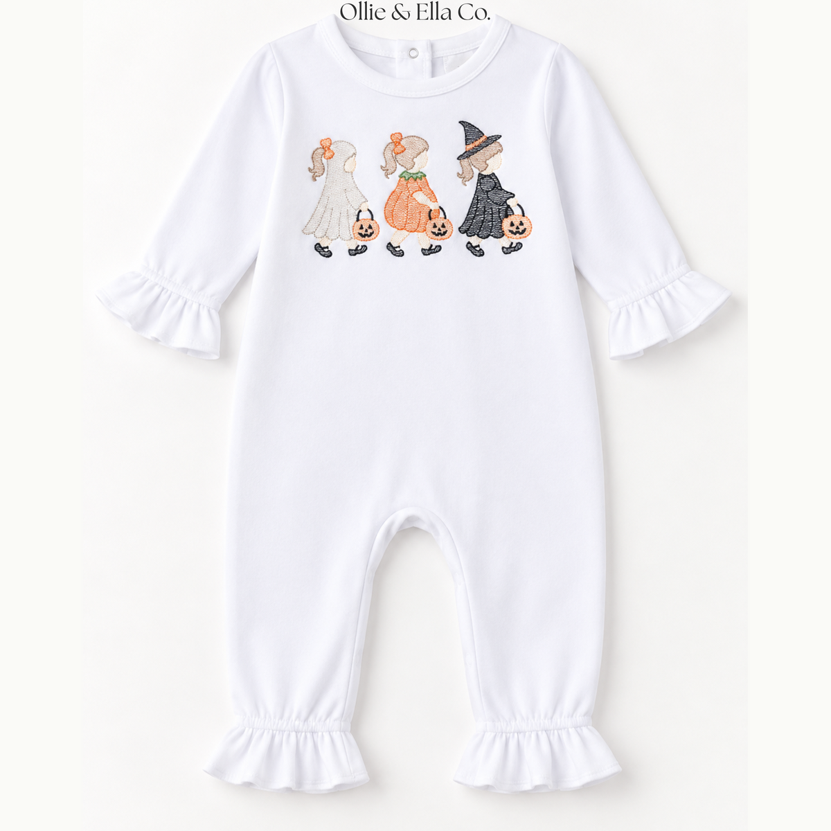 A white baby long-sleeve footless jumpsuit with ruffled cuffs and leg hems, featuring a cute Halloween graphic of a bride, pumpkin, witch, and pumpkin on the chest. The brand name 'Ollie & Ella Co.